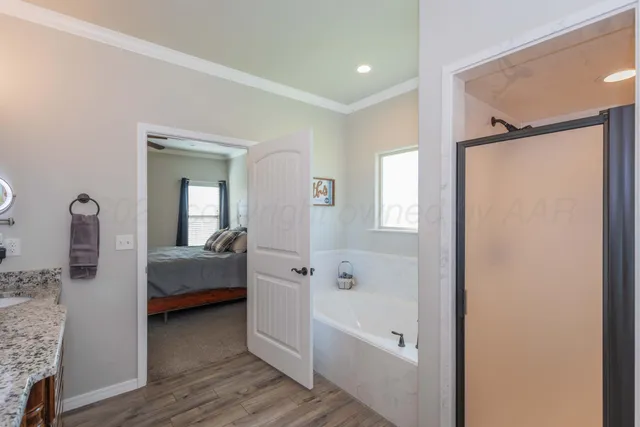 a bathroom with a bathtub a sink and mirrors
