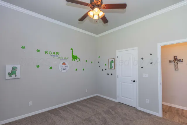 an empty room with closet and a chandelier fan