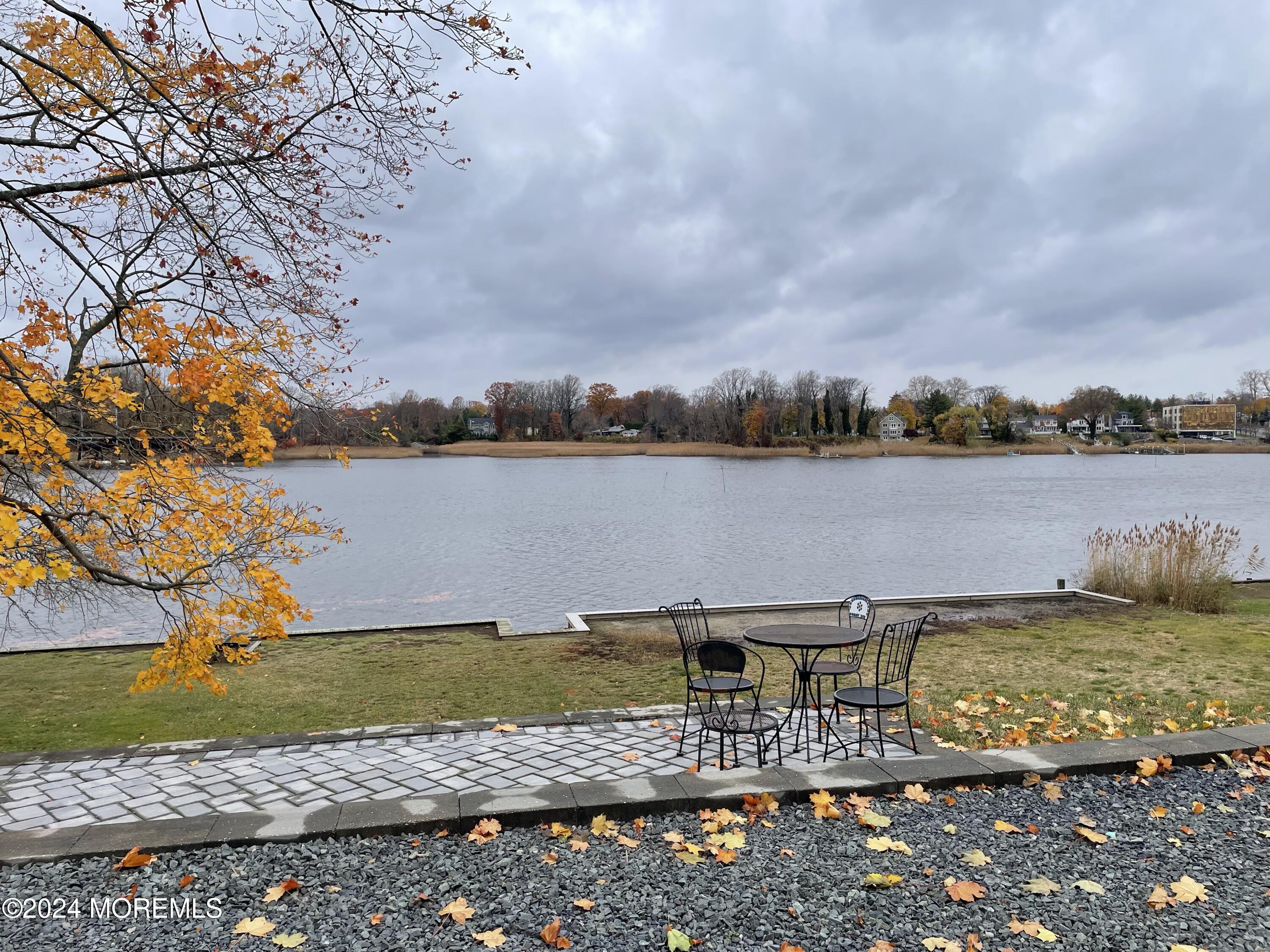 a view of a lake with houses in the back