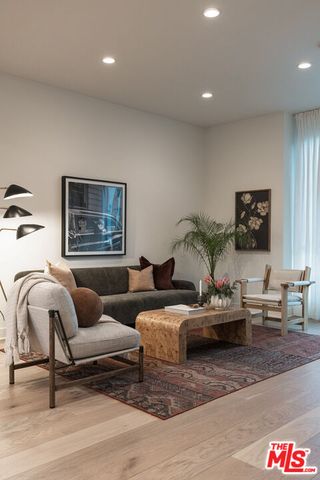 a living room with furniture and a lamp