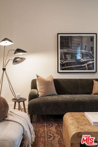 a living room with furniture and a lamp