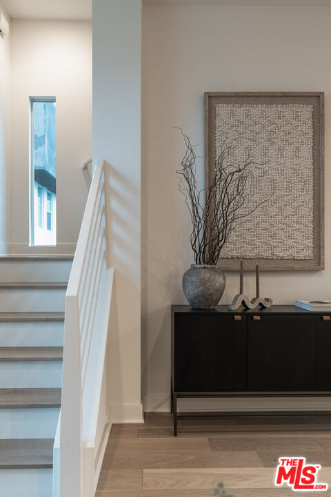 2210 Tom Mix Road Los Angeles, CA 90026 - Photo 18 of 45 a view of staircase with wooden floor and a potted plant