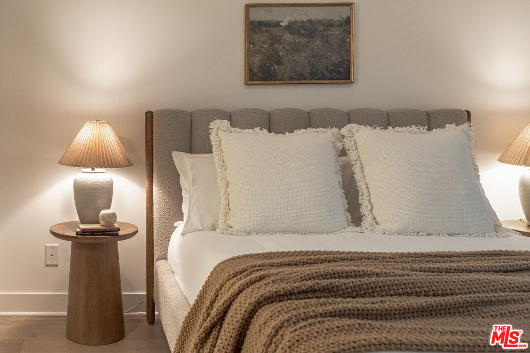2210 Tom Mix Road Los Angeles, CA 90026 - Photo 21 of 45 a bed with a white comforter and pillows
