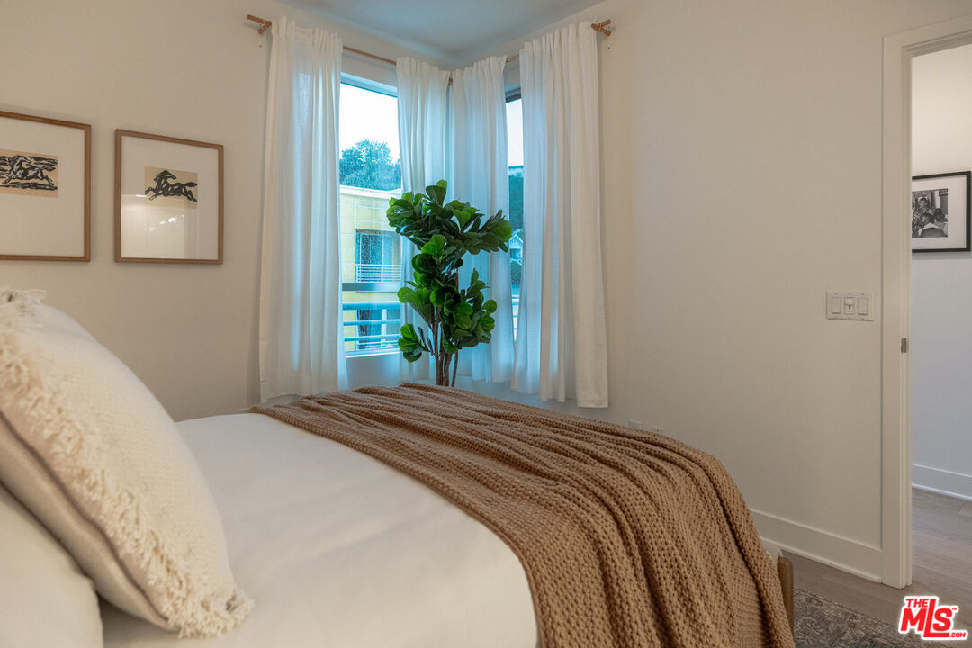 2210 Tom Mix Road Los Angeles, CA 90026 - Photo 22 of 45 a bedroom with a bed and a potted plant
