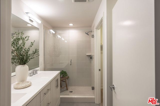 a bathroom with a granite countertop sink a toilet and shower