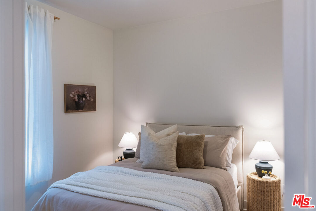 2210 Tom Mix Road Los Angeles, CA 90026 - Photo 30 of 45 a bedroom with a bed and a lamp