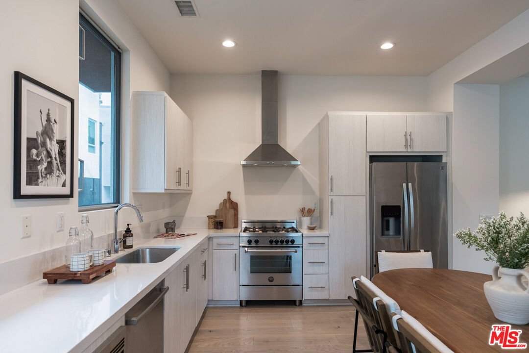 2210 Tom Mix Road Los Angeles, CA 90026 - Photo 3 of 45 a kitchen with granite countertop a sink stainless steel appliances and cabinets
