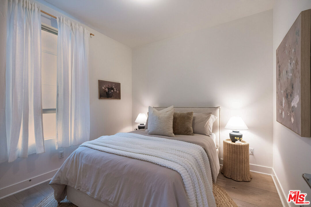 2210 Tom Mix Road Los Angeles, CA 90026 - Photo 32 of 45 a bedroom with a bed and a window