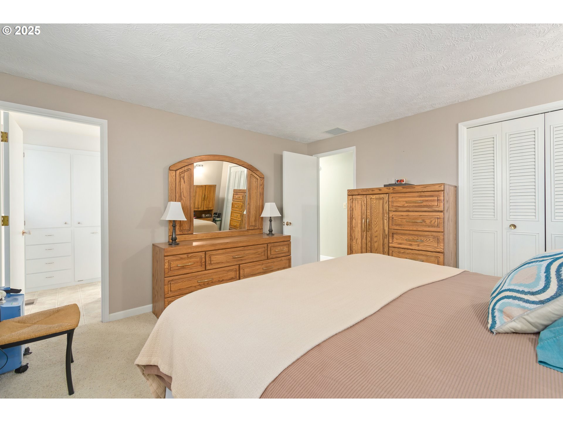 41886 Deerhorn Road Springfield, OR 97478 - Photo 27 of 48 a bedroom with a bed and dresser with mirror