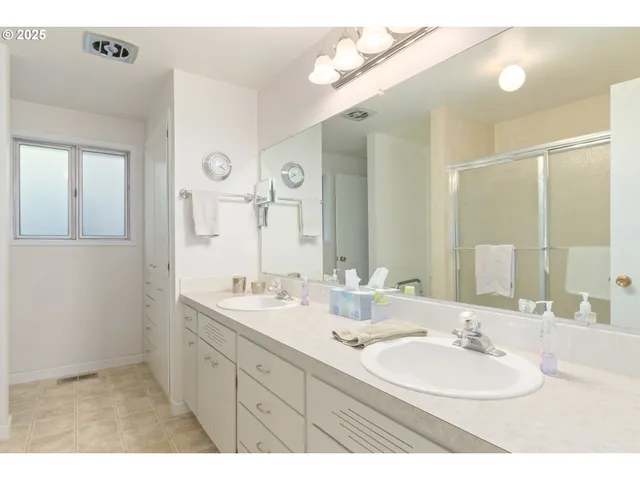 a bathroom with a double vanity sink mirror and double