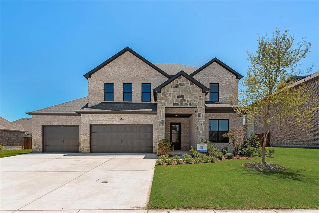 1327 Selby Road Van Alstyne, TX 75495 - Photo 2 of 32 View of front of property featuring brick siding, driveway, a front yard, and an attached garage