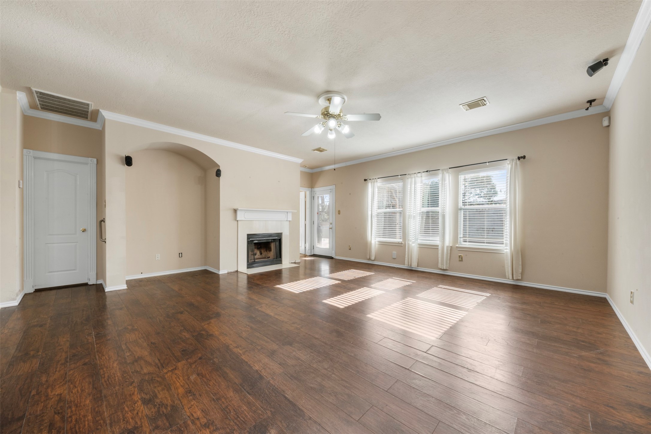 1839 Manor Drive Baytown, TX 77521 - Photo 3 of 26 a view of an empty room with wooden floor and a window