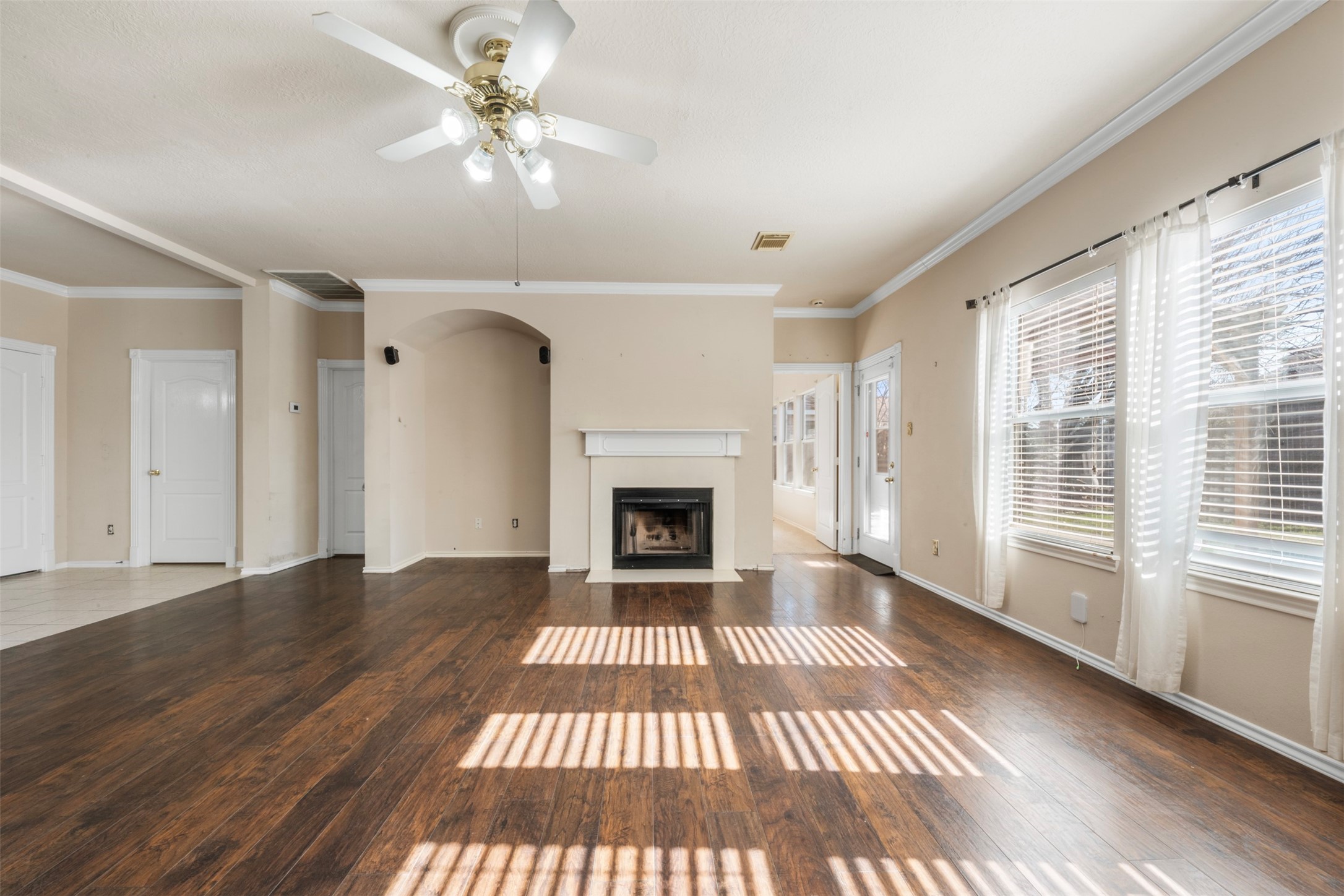 1839 Manor Drive Baytown, TX 77521 - Photo 6 of 26 a view of a livingroom with a fireplace a ceiling fan and windows