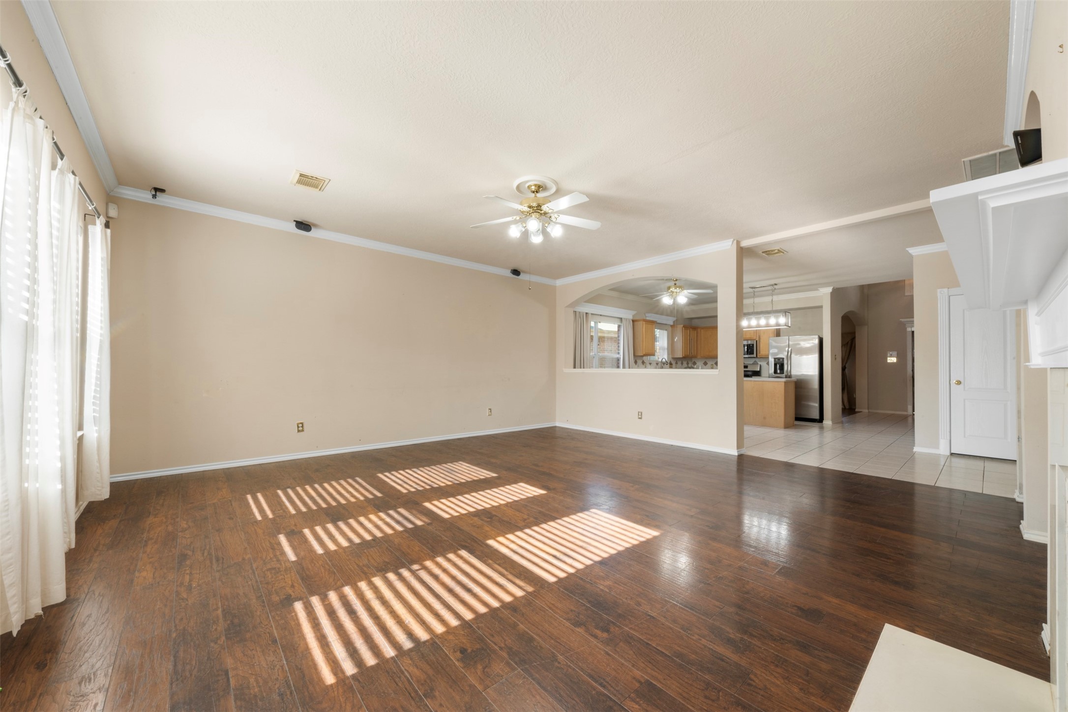 1839 Manor Drive Baytown, TX 77521 - Photo 7 of 26 a view of an empty room with window and wooden floor
