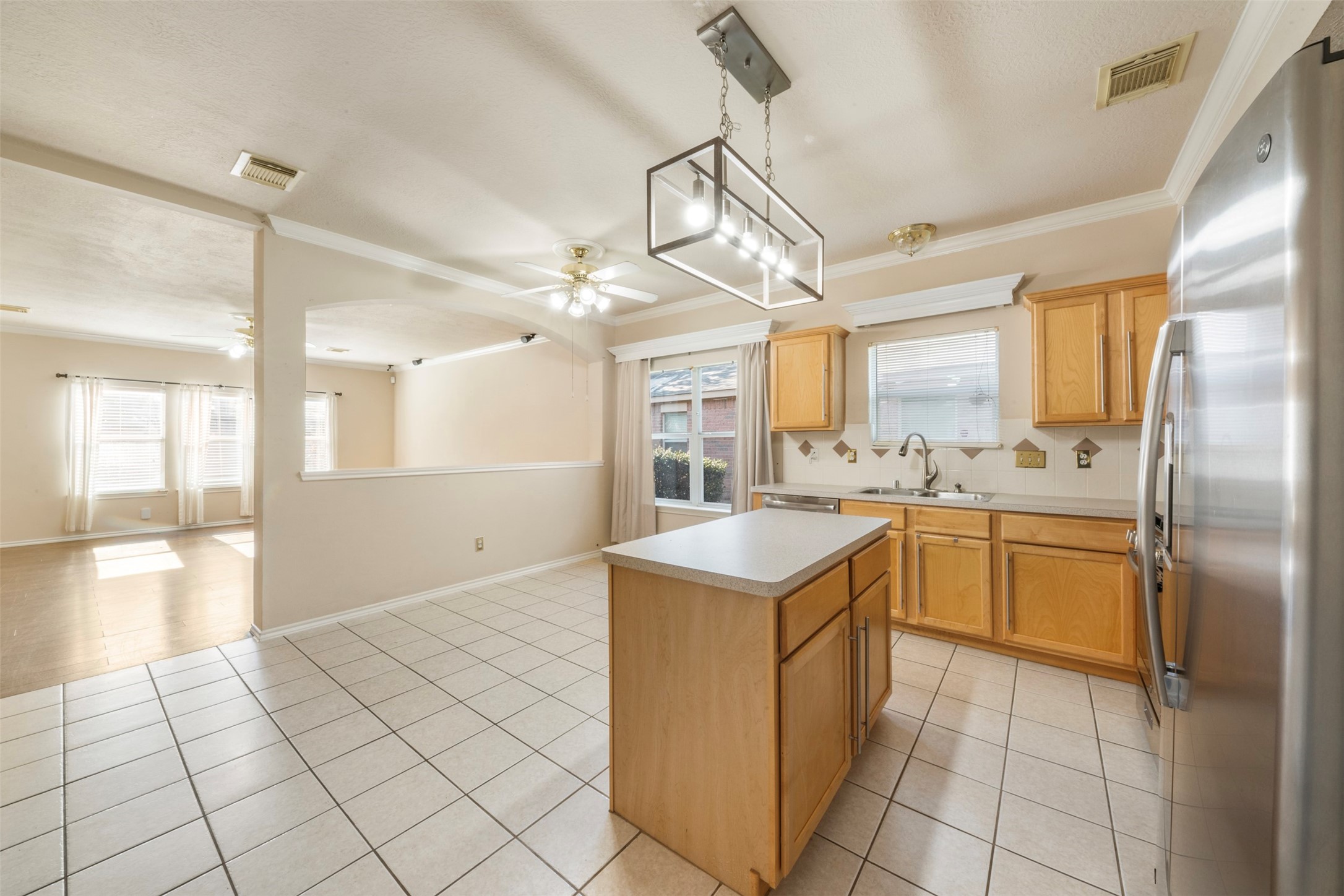 1839 Manor Drive Baytown, TX 77521 - Photo 8 of 26 a kitchen with a sink a stove cabinets and stainless steel appliances