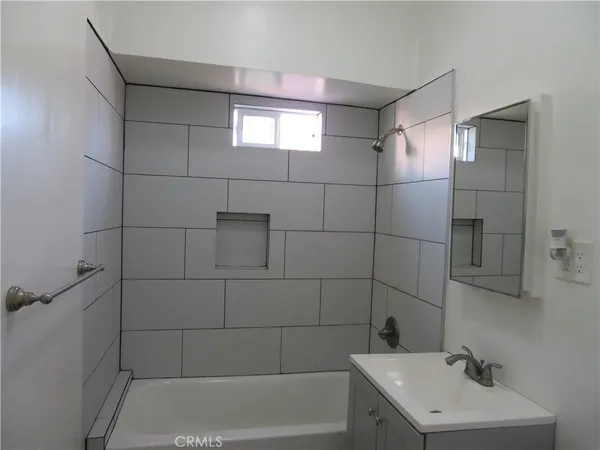 a bathroom with a shower toilet and sink