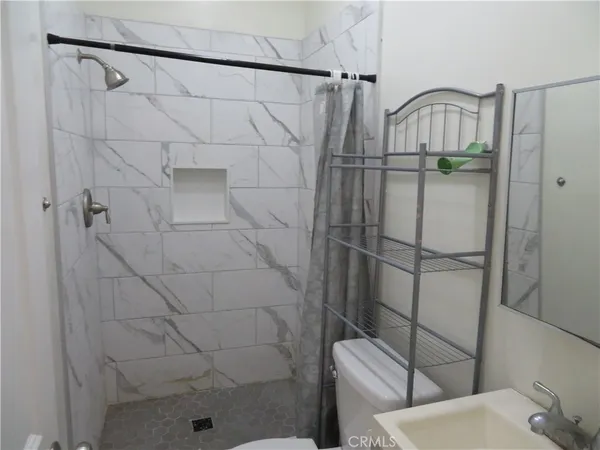 a bathroom with a sink a toilet and bathtub