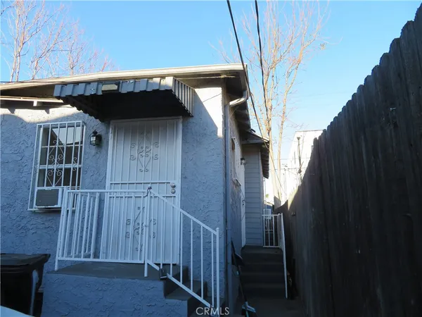 a view of a house with wooden fence
