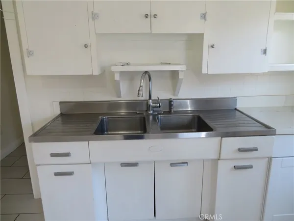 a kitchen with a sink and cabinets