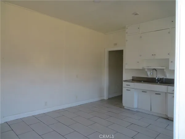 a kitchen with a sink cabinets and a window