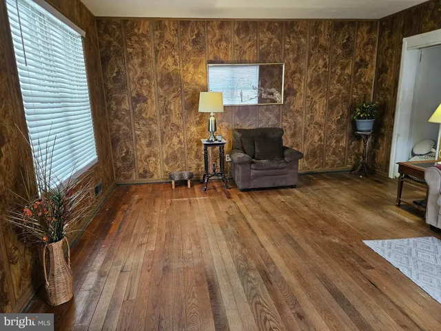 a living room with furniture and a lamp