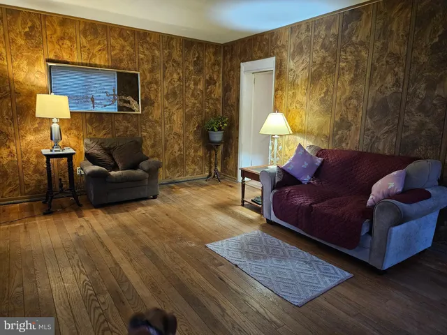 a kitchen with sink a refrigerator and wooden floor