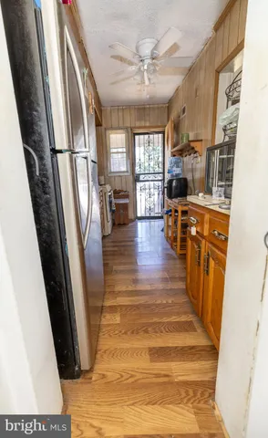 a kitchen with stainless steel appliances a refrigerator a sink a stove and cabinets
