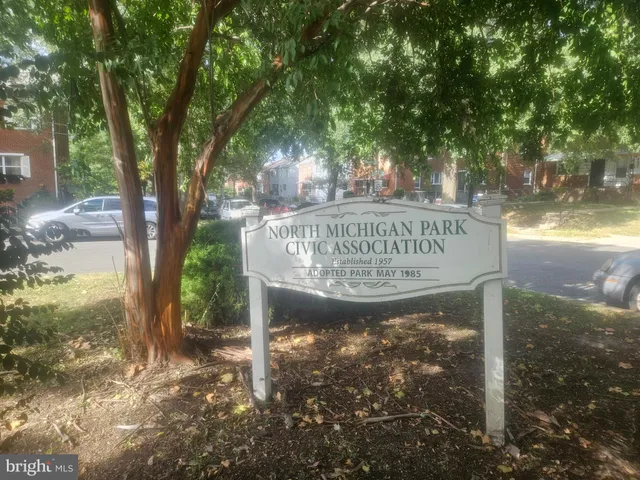 a view of a sign under a tree
