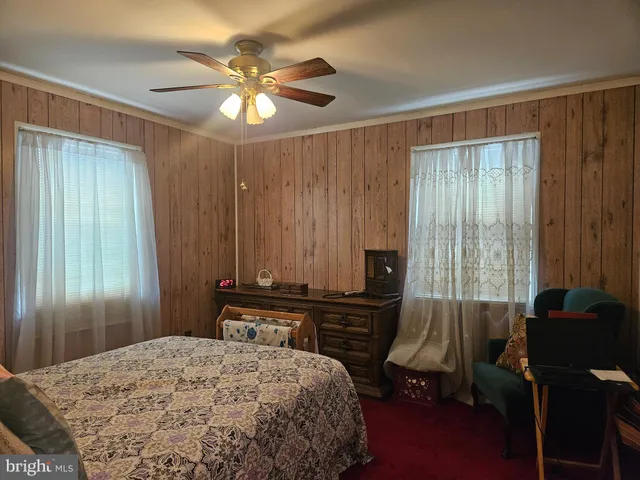 a bathroom with a toilet and a shower curtain