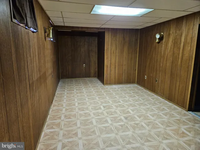 a view of a chairs and backyard with wooden fence