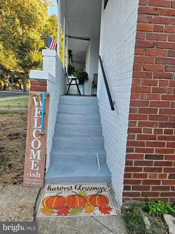 a view of a bench in a sidewalk