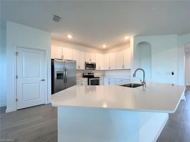 a view interior of a house with wooden floor windows and kitchen view