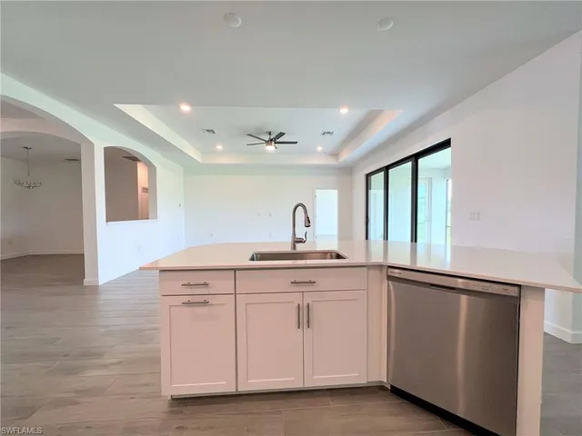 an empty room with large windows