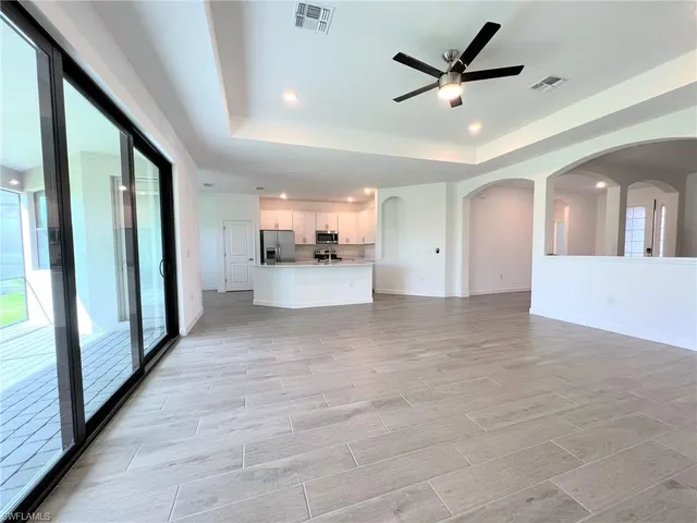 a kitchen with stainless steel appliances a refrigerator sink and wooden cabinets