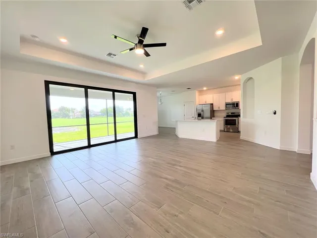 a kitchen with white cabinets and sink