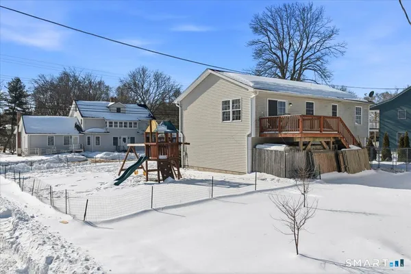 a view of a house with snow on the road