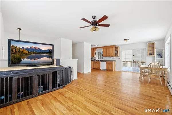 a view of a livingroom with wooden floor and a bookshelf