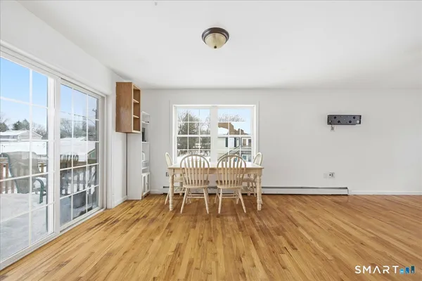 a view of a room with wooden floor and windows