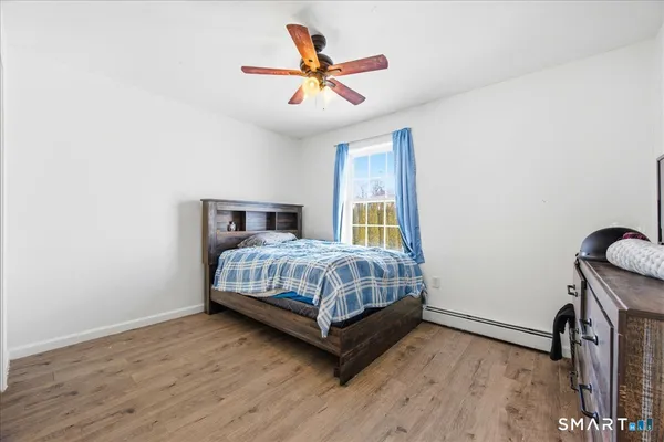a bedroom with a bed and a ceiling fan