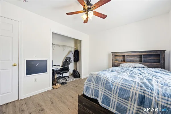 a bedroom with a bed and a chandelier