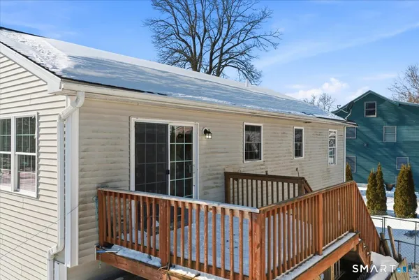 a view of a roof deck with wooden fence and floor