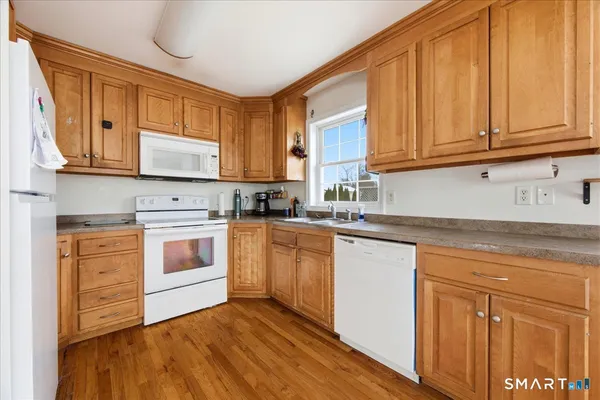 a kitchen with granite countertop cabinets stainless steel appliances and sink