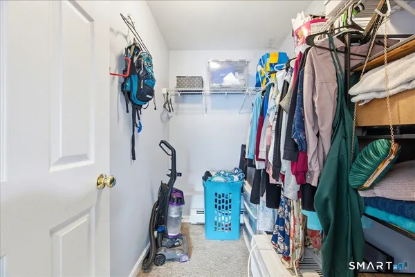 a view of walk in closet with clothes