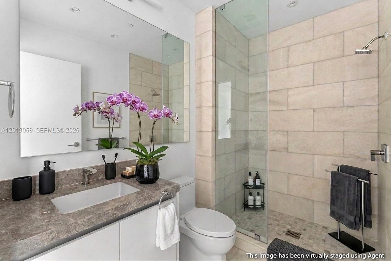 175 Southeast 25th Road, Unit 3601 Miami, FL 33129 - Photo 19 of 27 a bathroom with a granite countertop sink a toilet and shower