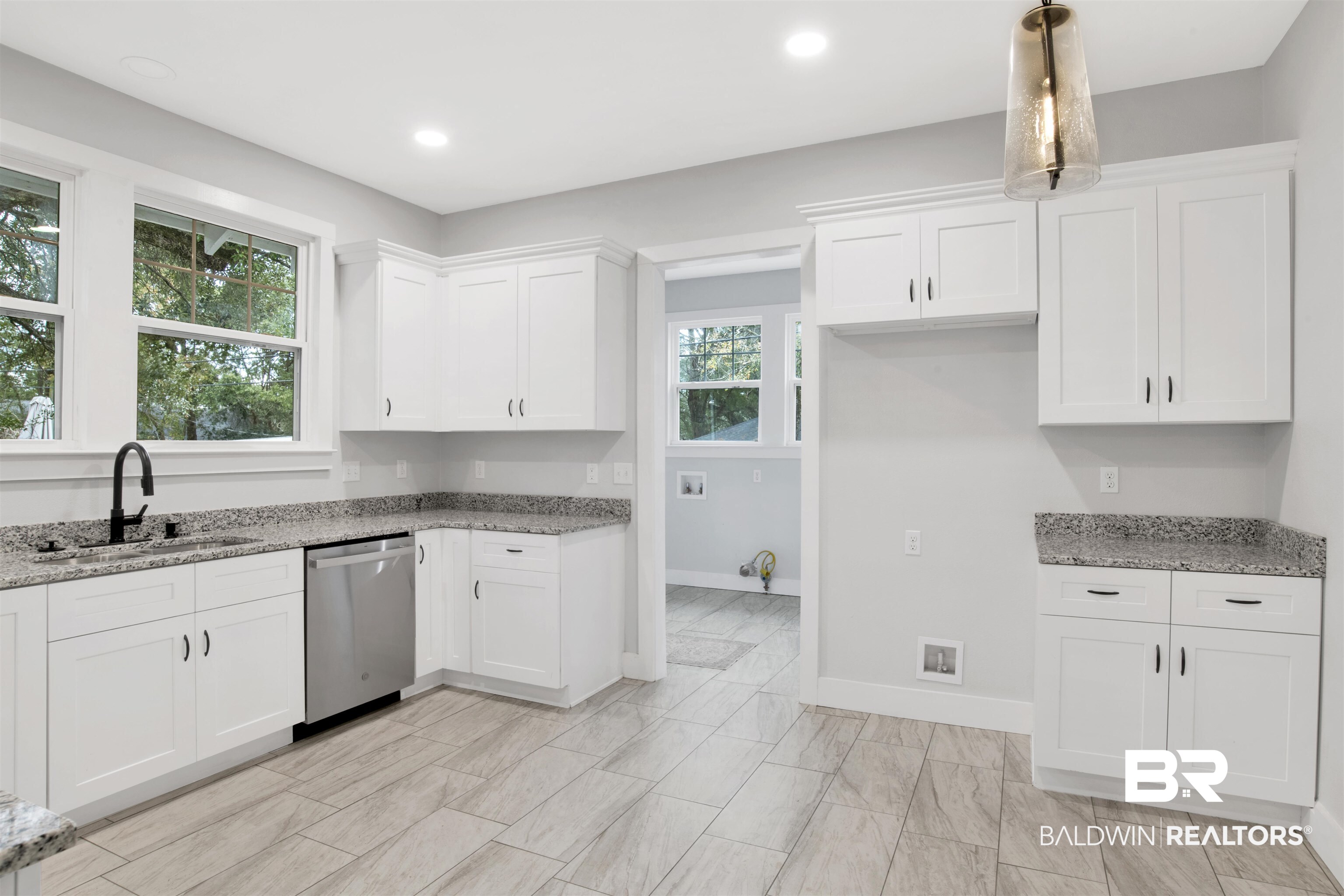 302 1st Street Mobile, AL 36611 - Photo 13 of 28 Kitchen with sink, hanging light fixtures, light stone countertops, white cabinets, and stainless steel dishwasher
