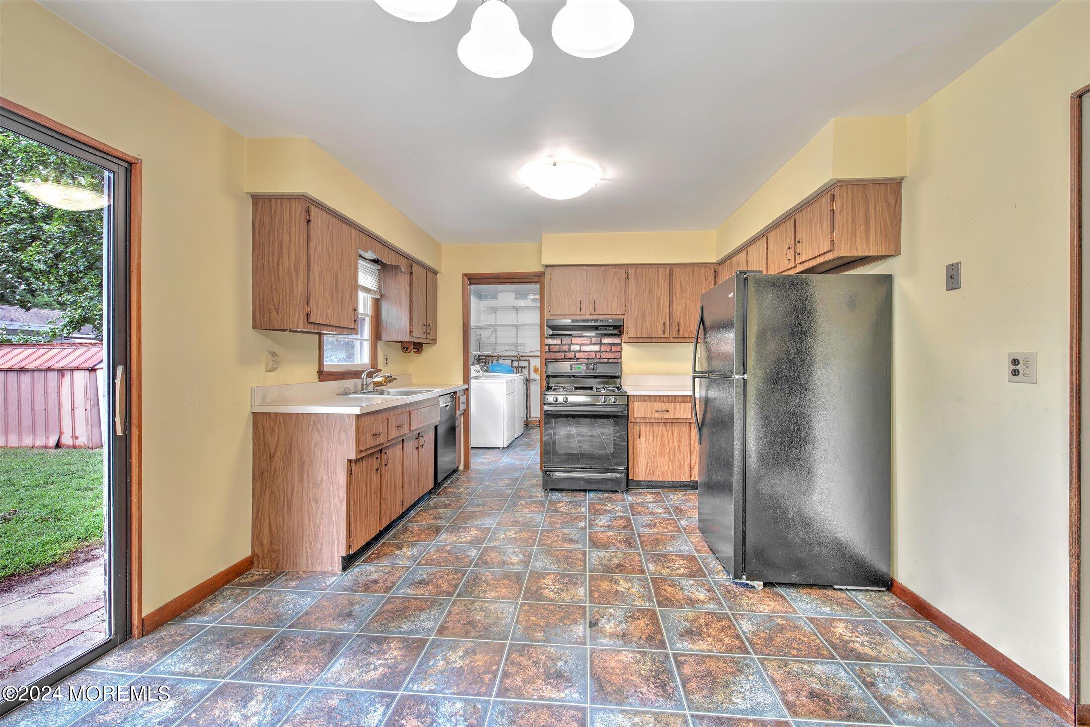 2209 Glen Oak Drive Forked River, NJ 08731 - Photo 12 of 44 a kitchen with a refrigerator sink and cabinets