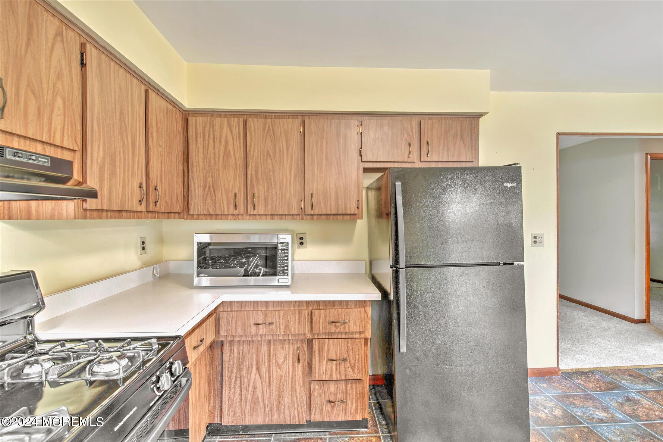 2209 Glen Oak Drive Forked River, NJ 08731 - Photo 17 of 44 a kitchen with stainless steel appliances granite countertop a refrigerator sink stove and cabinets