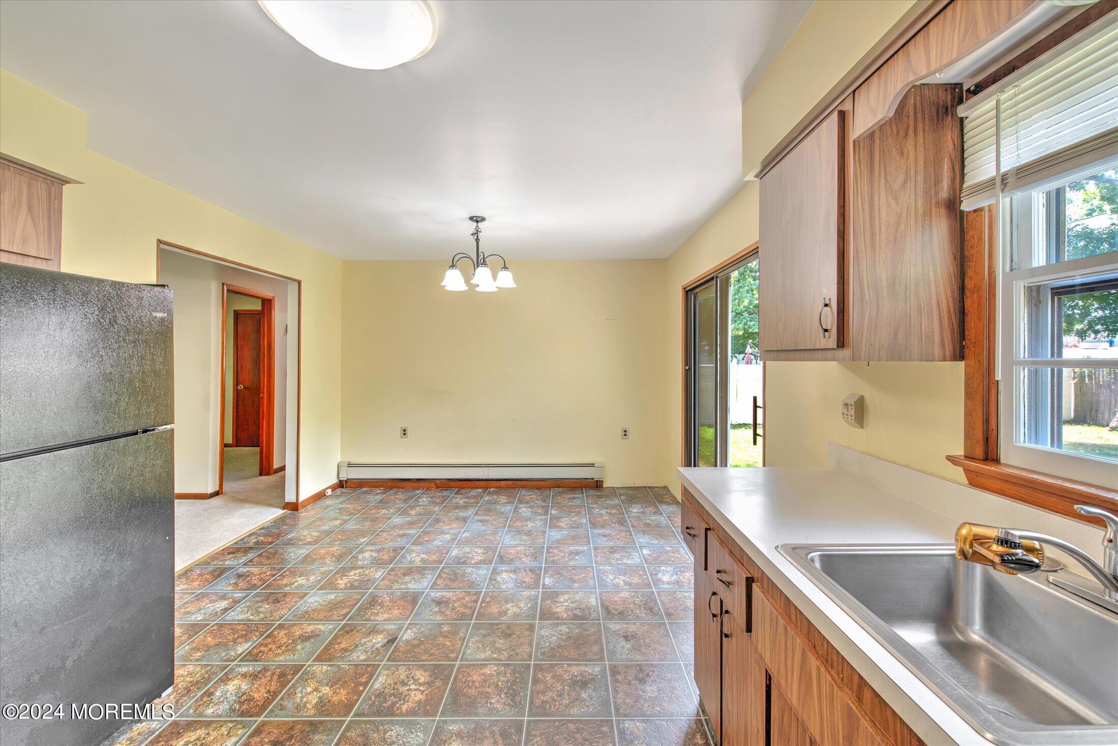 2209 Glen Oak Drive Forked River, NJ 08731 - Photo 18 of 44 a view of a kitchen with a sink and dishwasher with wooden floor