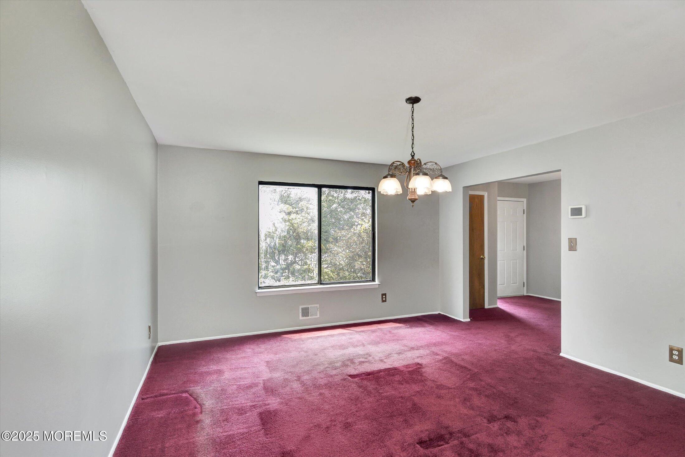 19 Northwoods Road Asbury Park, NJ 07712 - Photo 11 of 79 an empty room with windows and chandelier