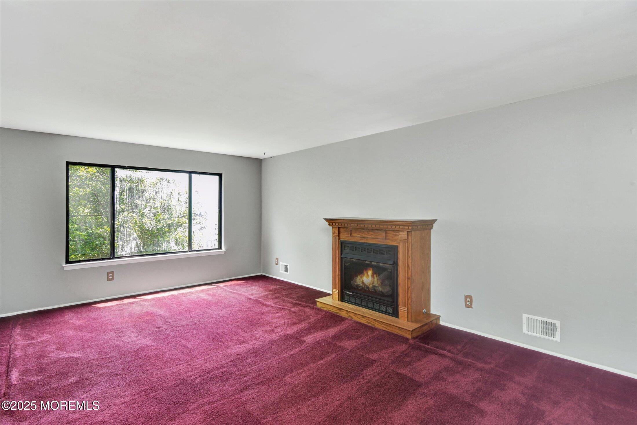 19 Northwoods Road Asbury Park, NJ 07712 - Photo 13 of 79 an empty room with windows and fireplace